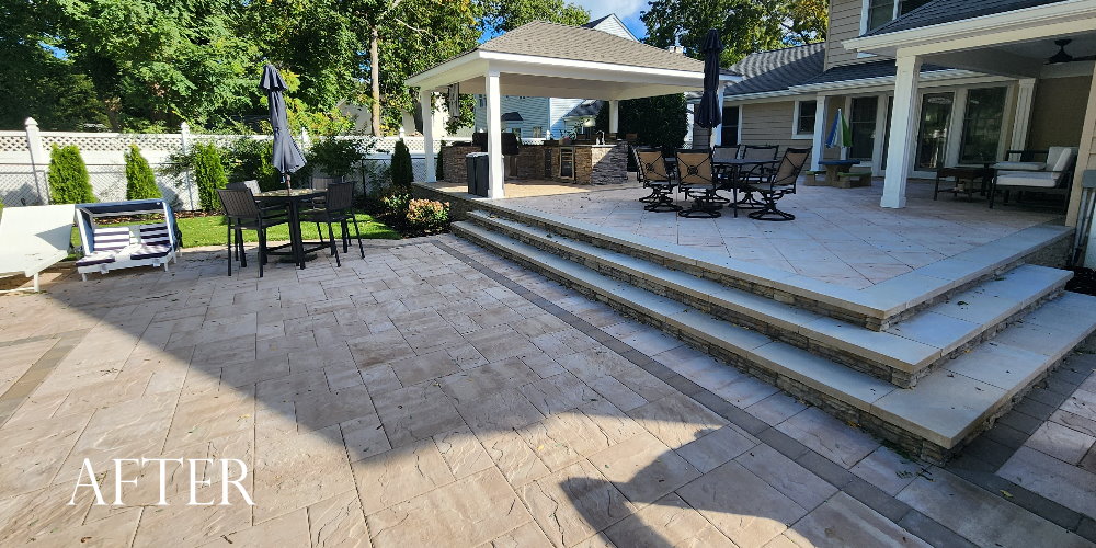 raised patio with outdoor bbq/bar island and pavilion. cambridge XL pavers